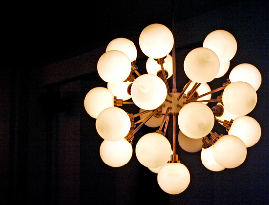 Minimalist room with potted trees and round wall mirrors